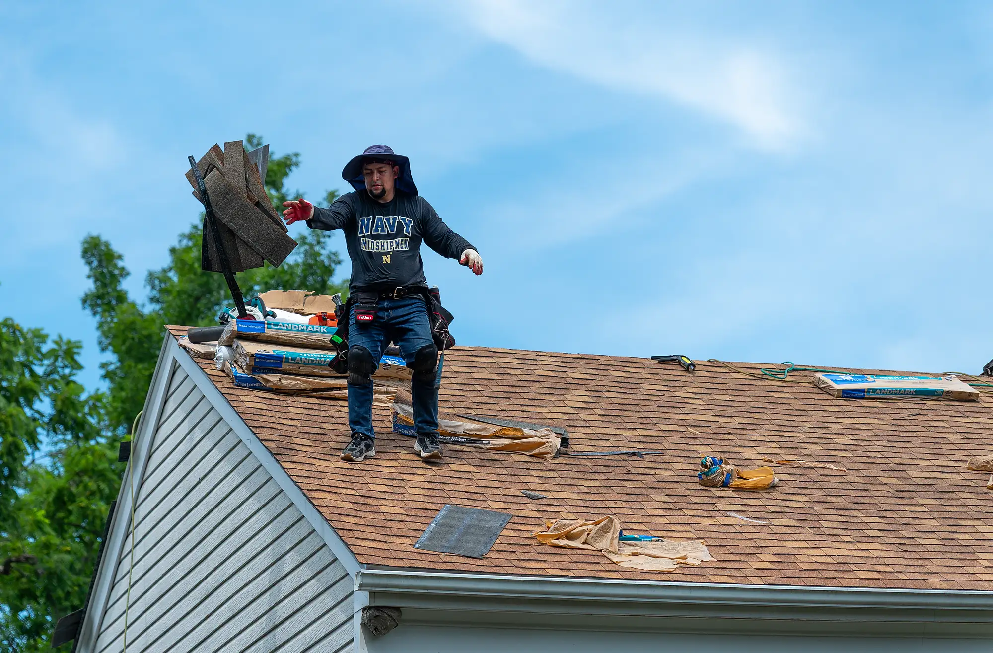 Contractors replacing old shingles with new roofing materials
