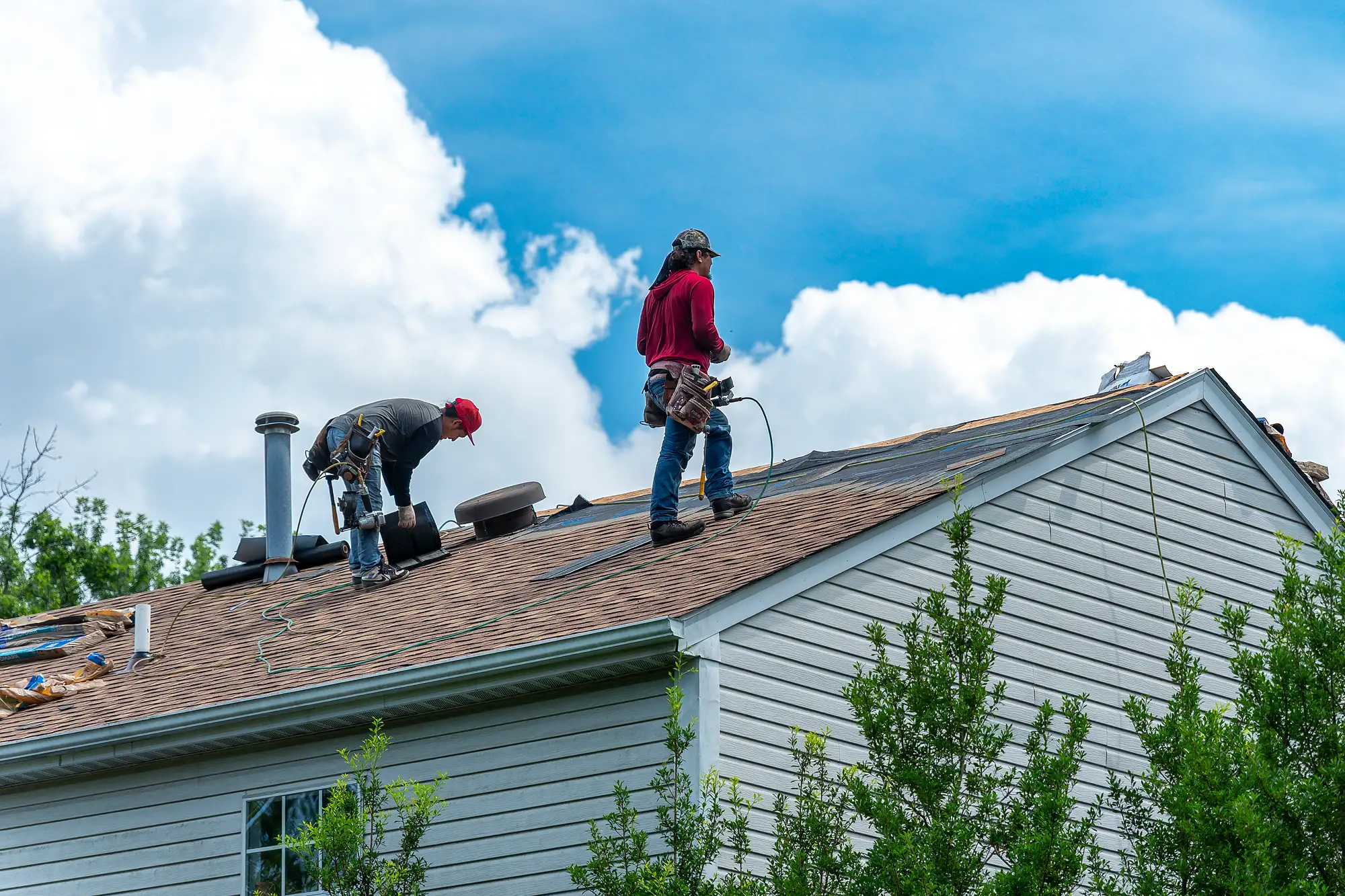 Roofing crew installing architectural shingles on a Northern Virginia home